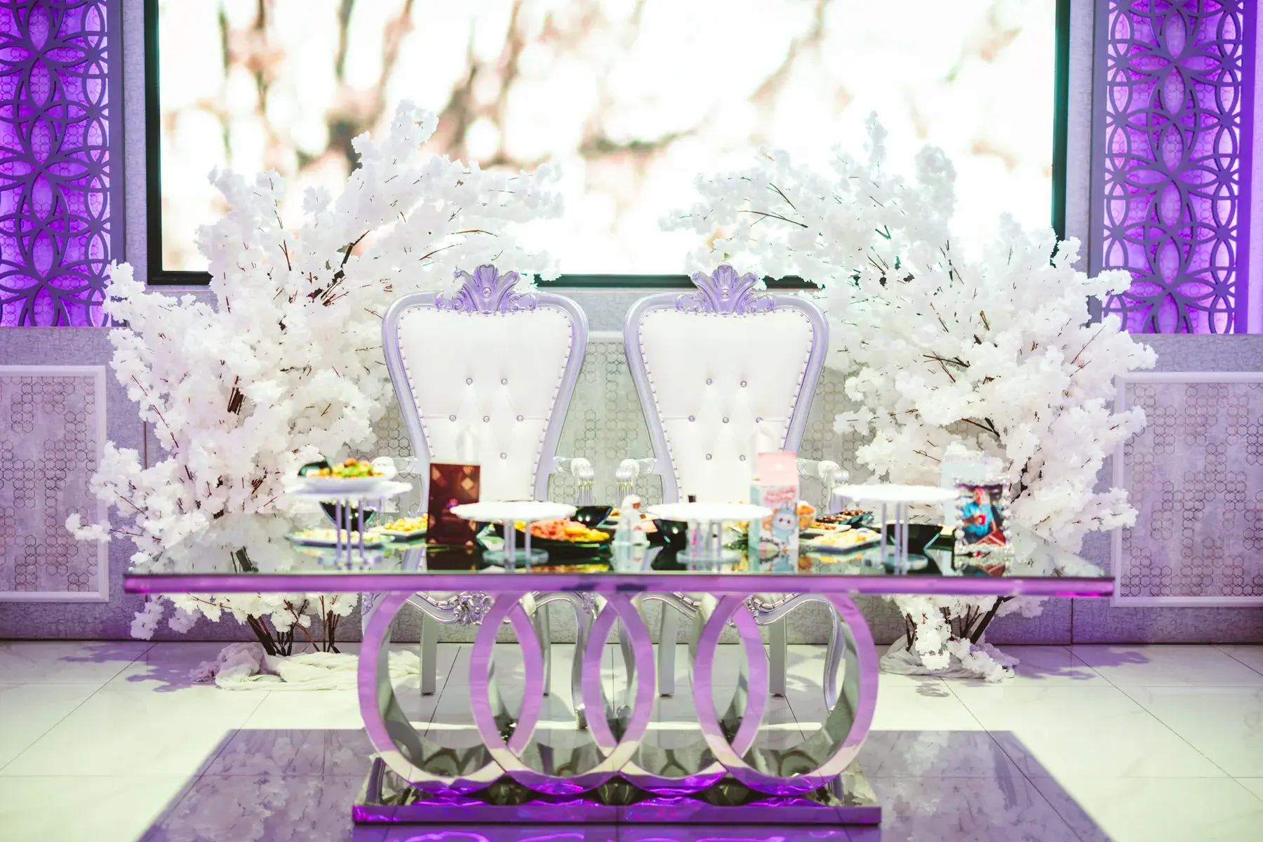 The cherry blossom arch behind a wedding sweetheart table